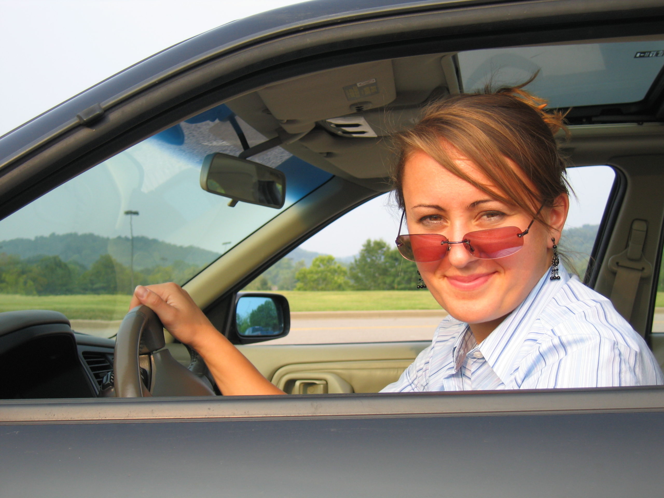 woman in the car wearing sunglasse