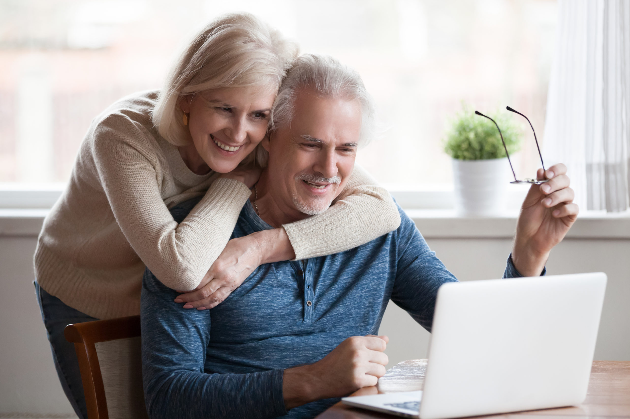 happy couple looking at laptop