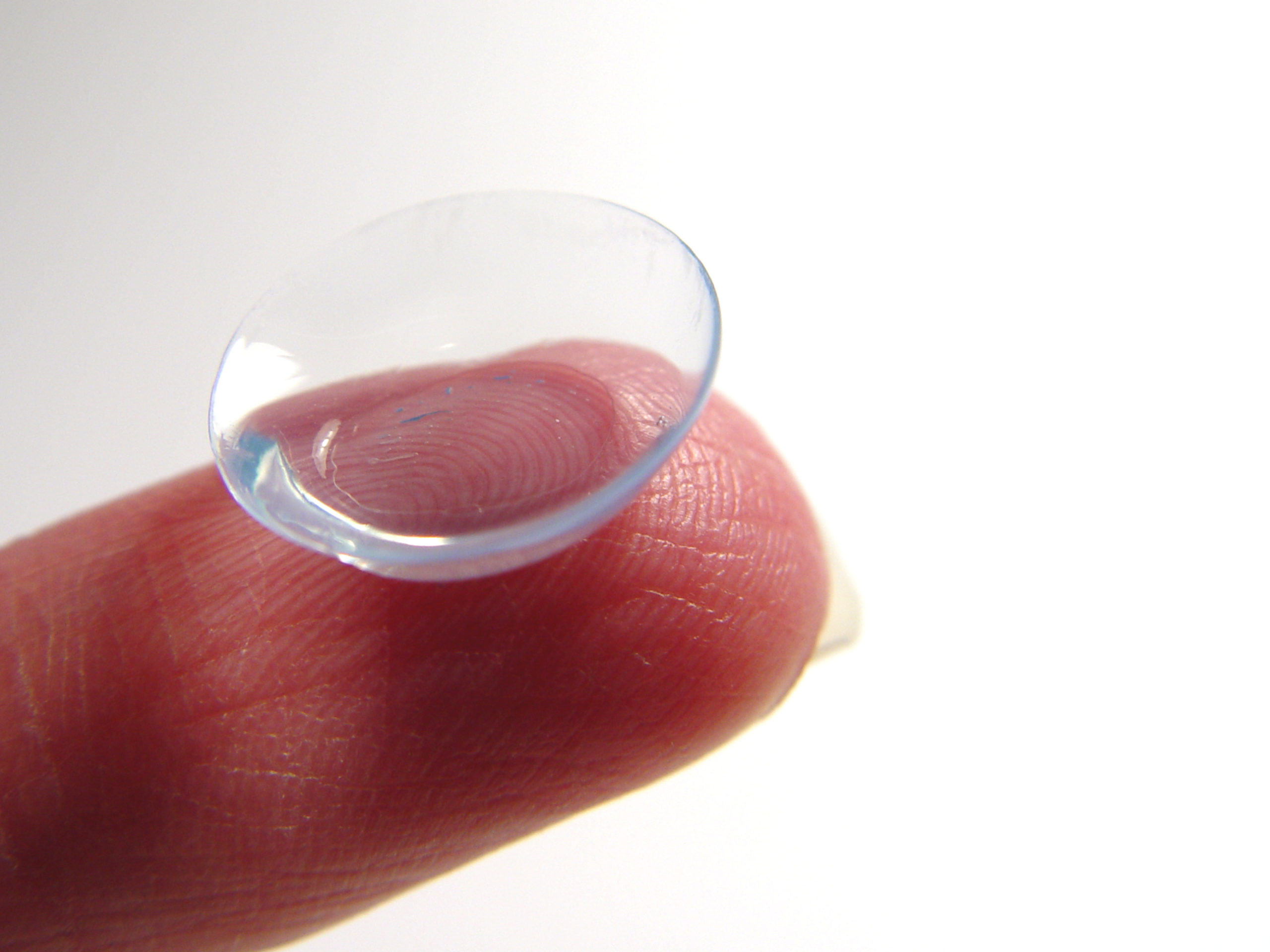 fingertip holding contact lens