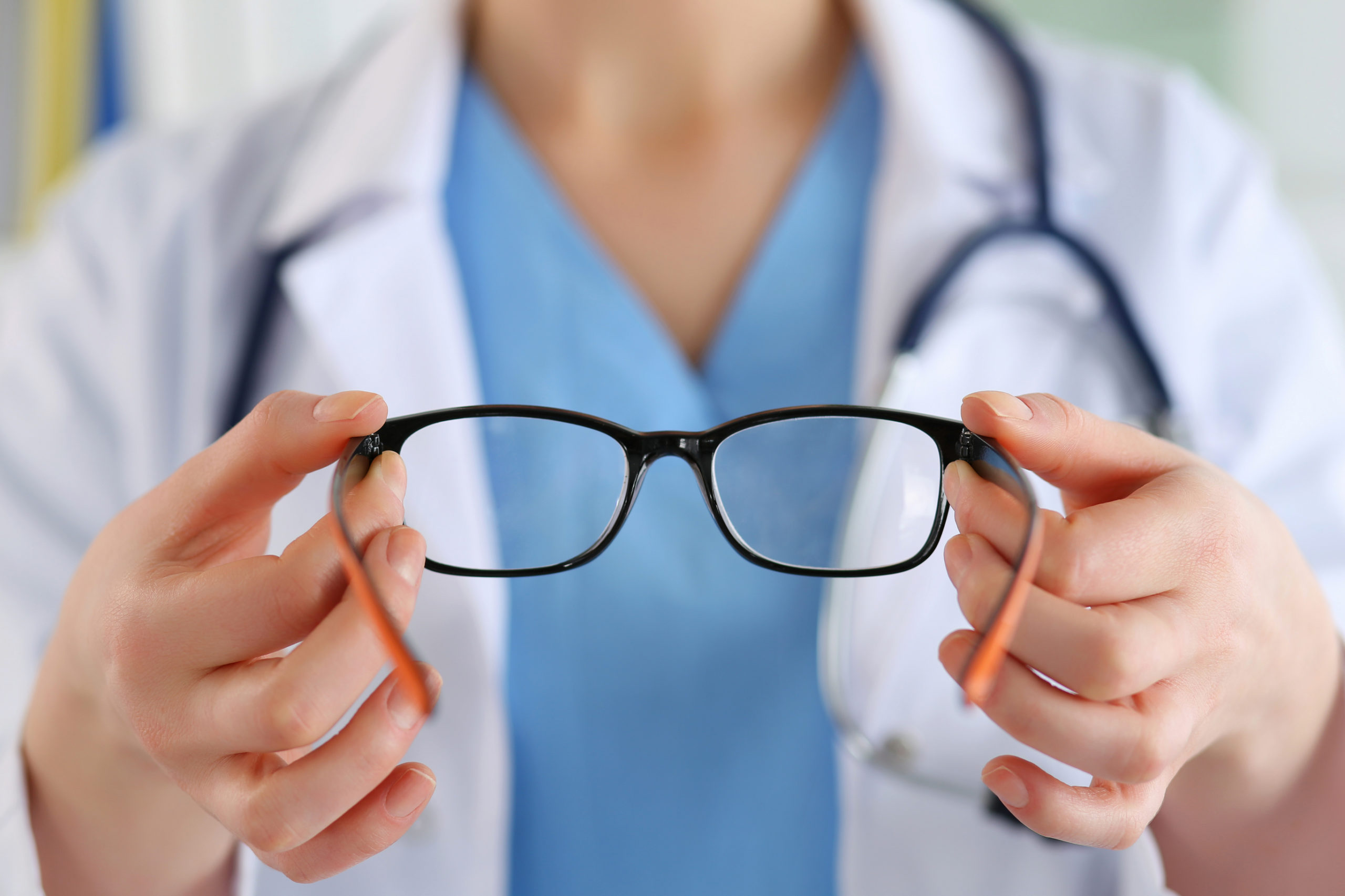 doctor holding prescription glasses