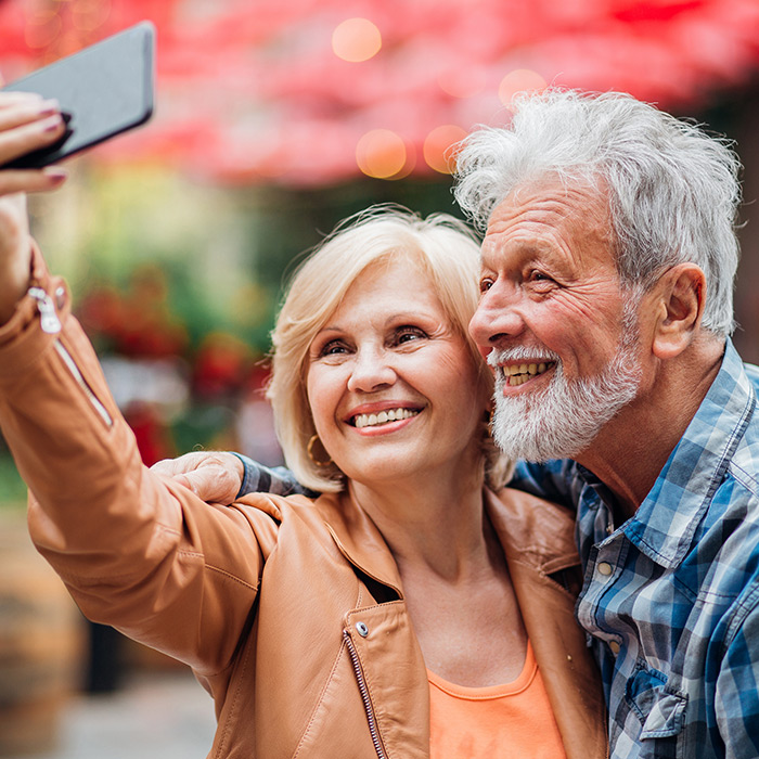 Older couple of eye care patients taking a selfie together and smiling