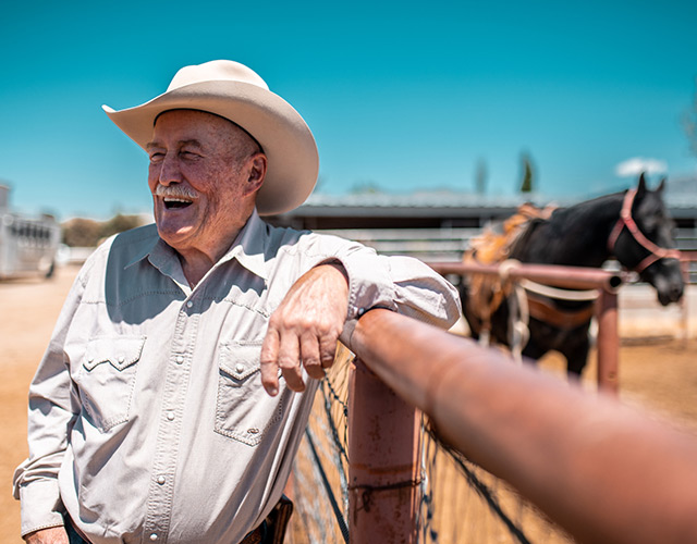 Older man with cowboy hat enjoying his ranch: Eye care patient