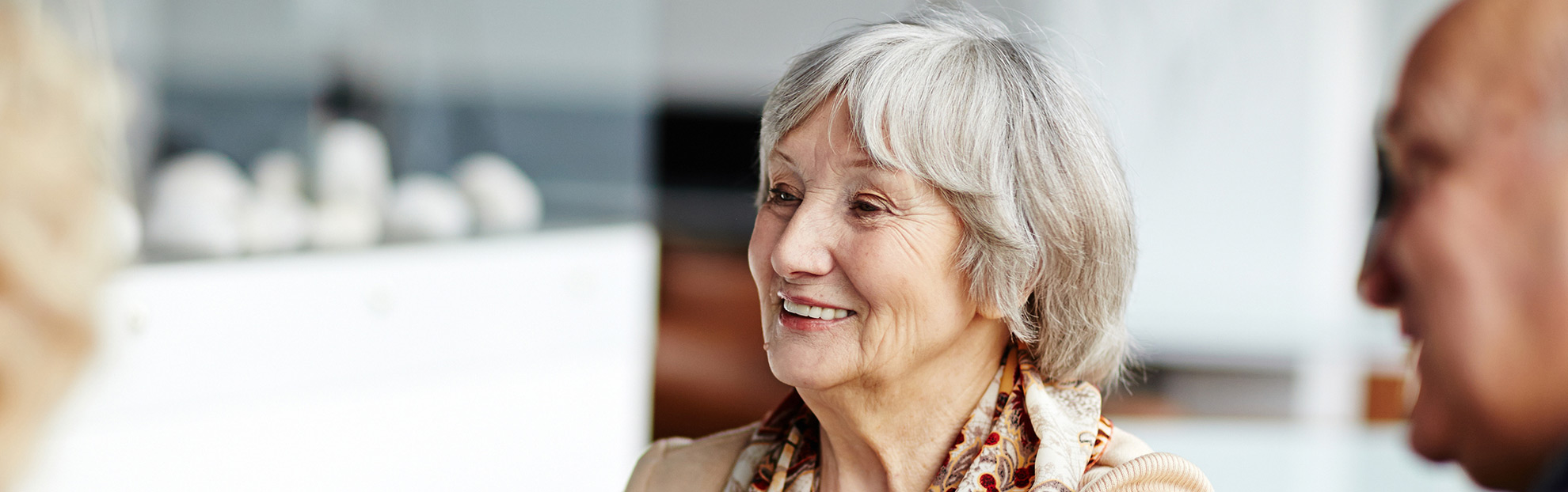 Woman enjoying tea with friends after cataract surgery recovery