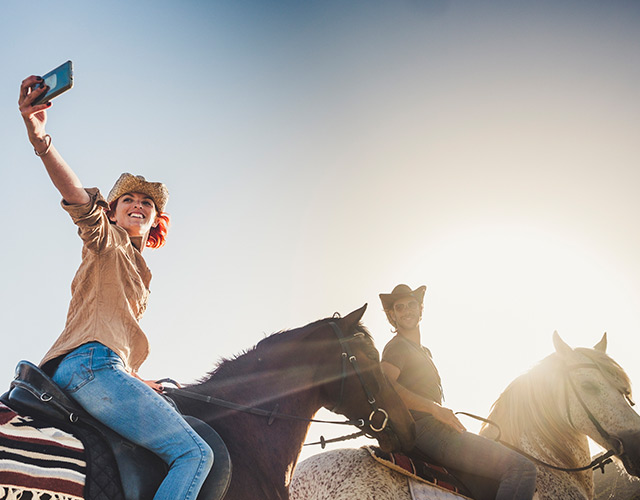 Happy Arizona eye care patient taking selfie horseback riding